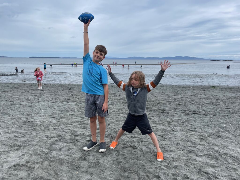 Two students posing on the beach during Beach Day.